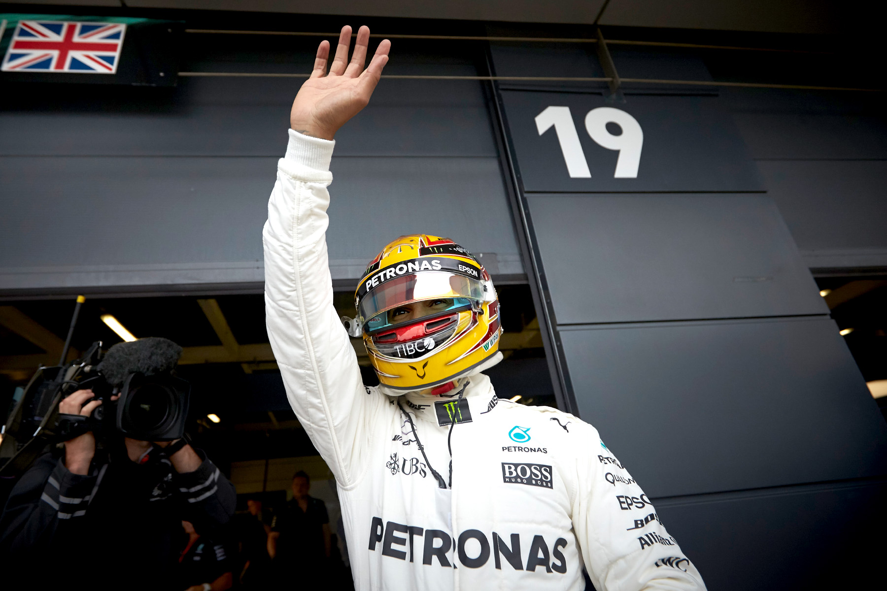 Lewis Hamilton waves to the crowd from the pit lane at the 2017 British Grand Prix.