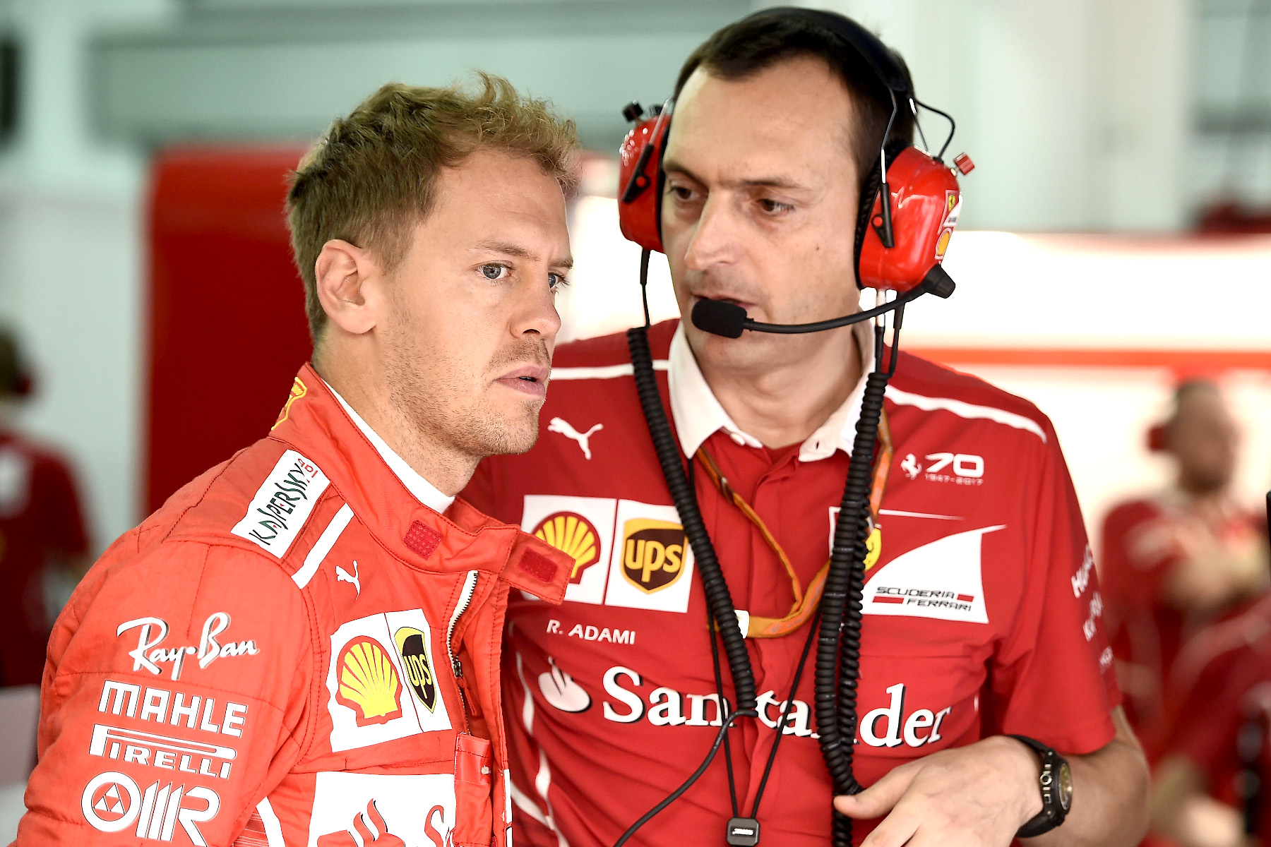 Sebastian Vettel talks with an engineer at the 2017 Malaysian Grand Prix.