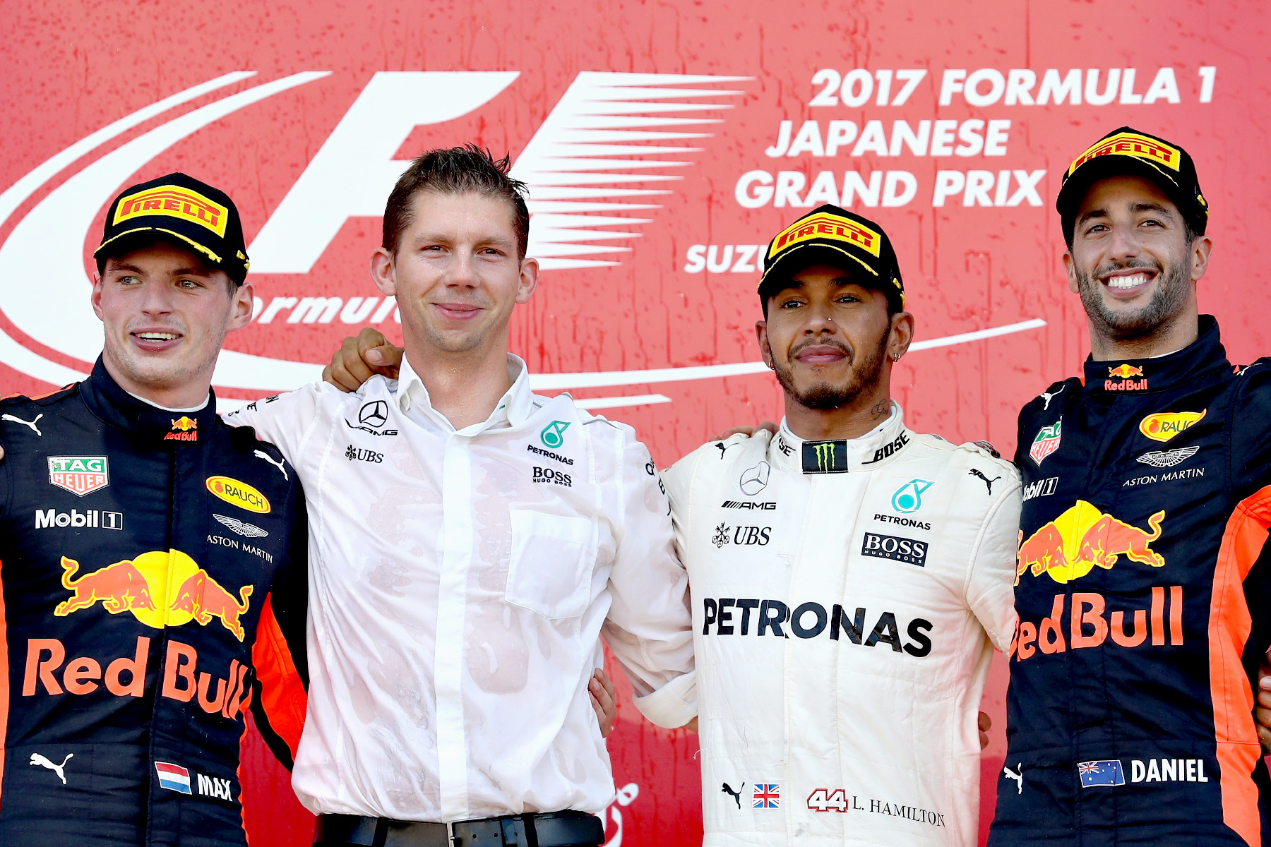 Max Verstappen, Lewis Hamilton and Daniel Ricciardo celebrate on the podium with Mercedes strategist James Vowels on the podium of the 2017 Japanese Grand Prix.