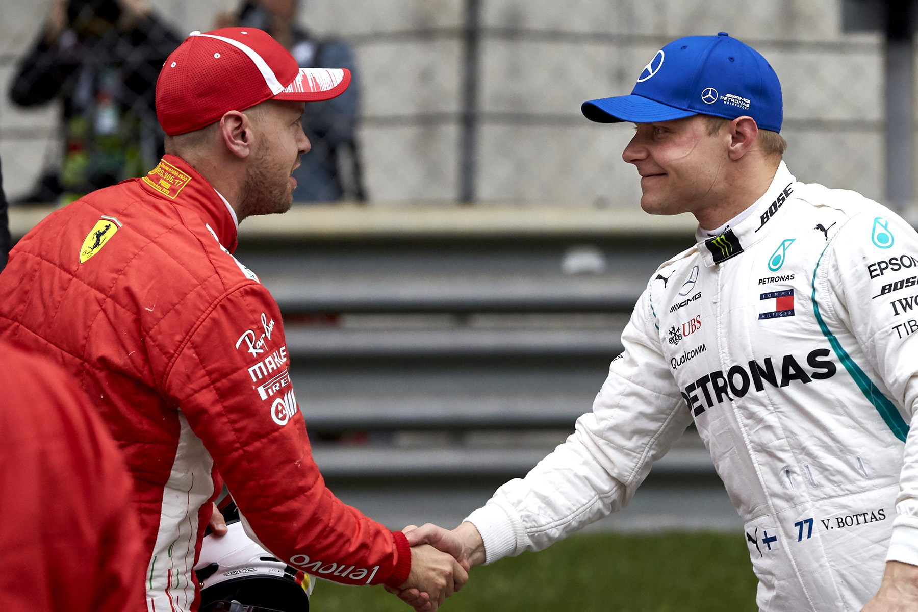 Sebastian Vettel and Valtteri Bottas shake hands after qualifying first and third for the 2018 Chinese Grand Prix.