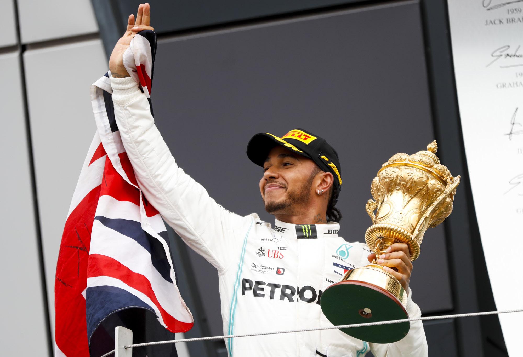 Lewis Hamilton celebrates with the British Grand Prix podium.
