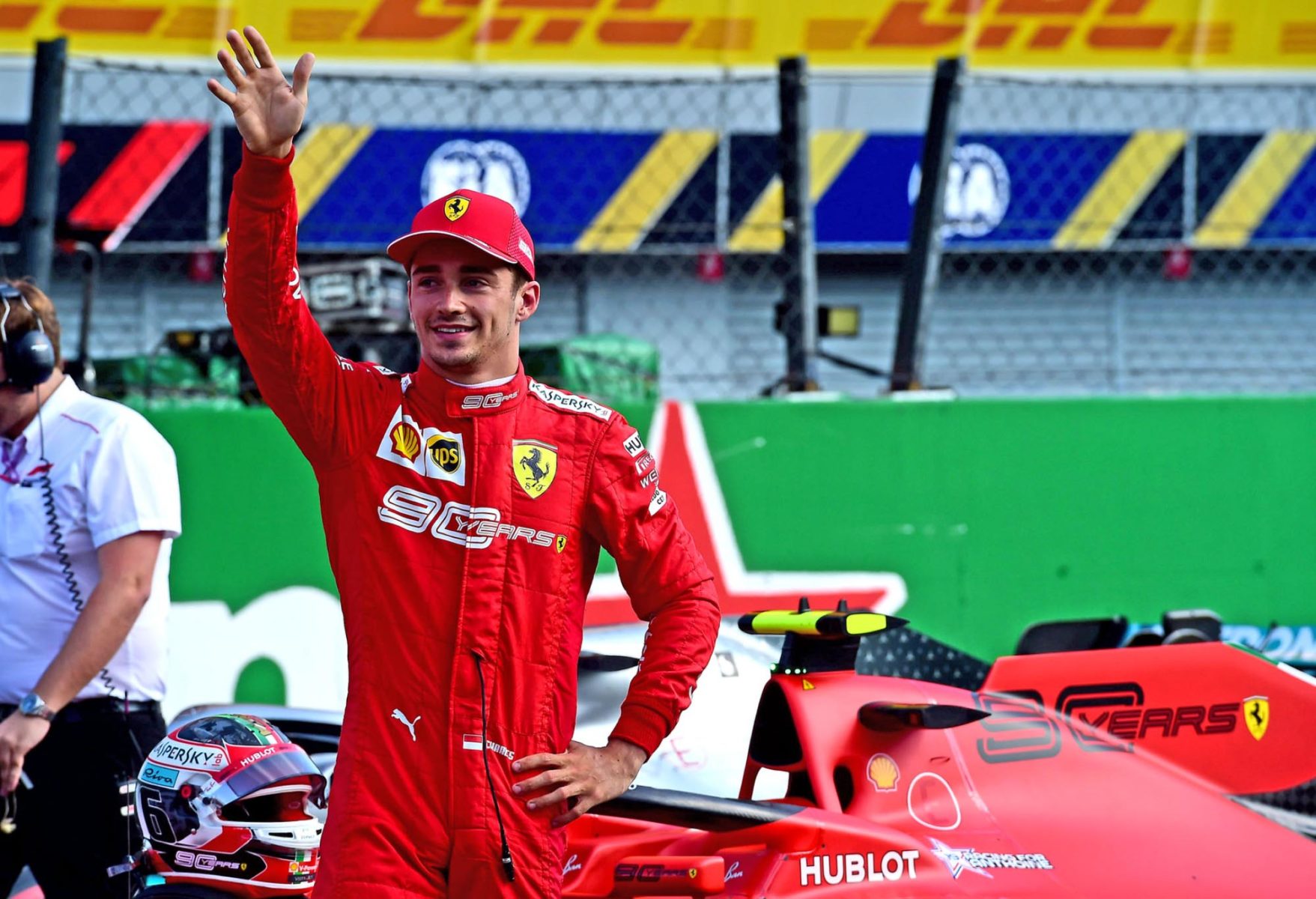 Charles Leclerc waves to the crowd after claiming pole position